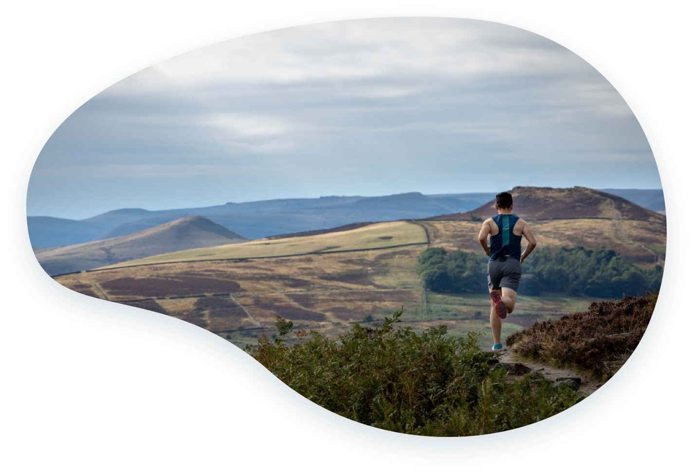 Person running outside with mountains in the distance.